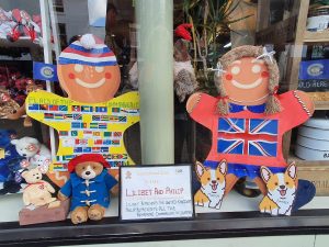 Trail runner up 2023 Two Gingerbread characters in a shop window in Market Drayton dressed to celebrate the Commonwealth with Paddington Bear